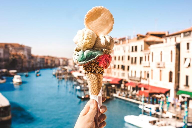 Delicious icecream in beautiful Venice, Italy in front of a canal and historic buildings